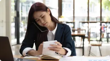 woman on call while looking at note